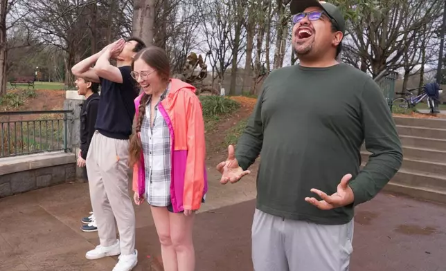 People participate in a Scream Club meeting at Piedmont Park, Sunday, March 8, 2026, in Atlanta. (AP Photo/Emilie Megnien)