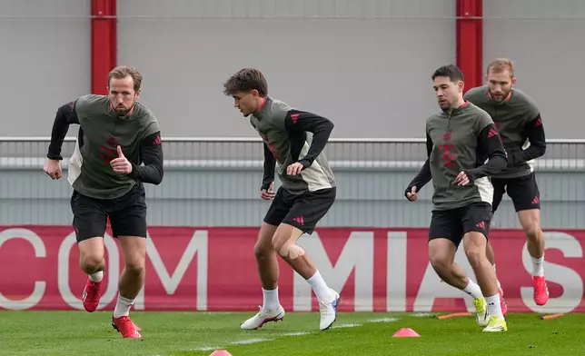 Bayern's Harry Kane, from left, Tom Bischof, Raphael Guerreiro and Konrad Laimer warm up during a training session in Munich, Germany, Monday, March 9, 2026, ahead of the Champions League round of 16 soccer match between Atalanta Bergamo and FC Bayern. (AP Photo/Matthias Schrader)