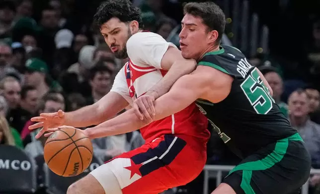 Boston Celtics center Luka Garza, right, steals the ball from Washington Wizards forward Tristan Vukcevic, left, during the first half of an NBA basketball game, Saturday, March 14, 2026, in Boston. (AP Photo/Charles Krupa)