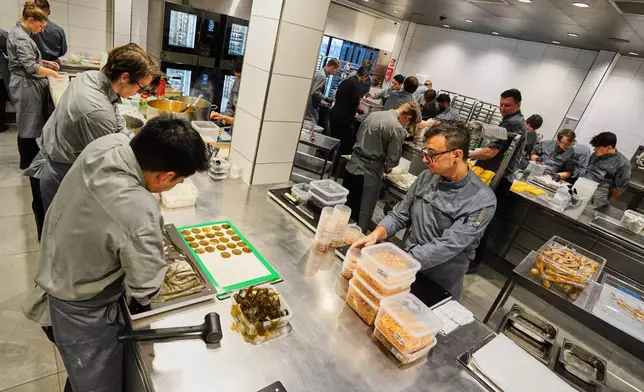 Chefs prepare the dishes inside the prep kitchen at restaurant Alchemist in Copenhagen, Denmark, Feb. 11, 2026. (AP Photo/James Brooks)