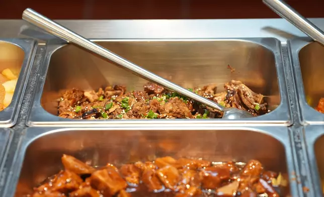 If you find slightly high blood pressure in the AI diagnosis, the system will trigger a red alert when you reach for braised pork, indicating the dish was unsuitable for your health condition. Photo by Bastille Post