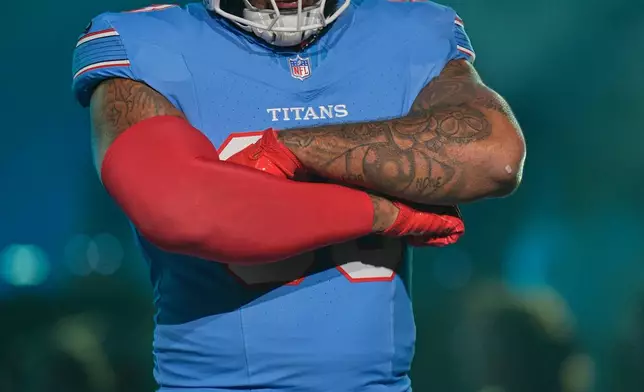 Tennessee Titans defensive tackle Jeffery Simmons models a new uniform during the NFL football team's event Thursday, March 12, 2026, in Nashville, Tenn. (AP Photo/George Walker IV)