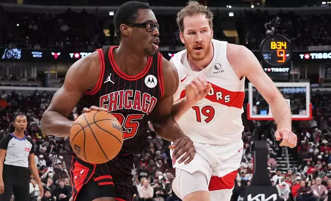 Chicago Bulls center Jalen Smith, left, drives as Toronto Raptors center Jakob Poeltl guards during the first half of an NBA basketball game in Chicago, Wednesday, March 18, 2026. (AP Photo/Nam Y. Huh)