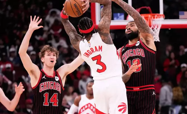 Chicago Bulls center Nick Richards, right, and forward Matas Buzelis, left, guard Toronto Raptors forward Brandon Ingram during the first half of an NBA basketball game in Chicago, Wednesday, March 18, 2026. (AP Photo/Nam Y. Huh)