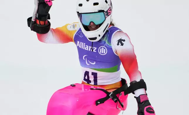 FILE - Spain's Audrey Pascual Seco reacts after crossing the finish line to win the bronze medal in the alpine skiing women's giant slalom sitting at the 2026 Winter Paralympics, in Cortina d'Ampezzo, Italy, March 14, 2026. (AP Photo/Evgeniy Maloletka, File)