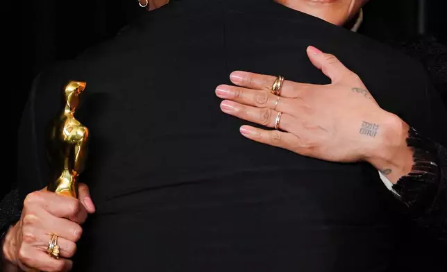 FILE - Michael B. Jordan, left, and Autumn Durald Arkapaw, winner of the award for cinematography for "Sinners," hug as they pose in the press room at the Oscars, March 15, 2026, at the Dolby Theatre in Los Angeles. (Photo by Jordan Strauss/Invision/AP, File)