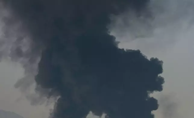 FILE - Fire and plumes of smoke rise from an oil facility in Fujairah, United Arab Emirates, March 14, 2026. (AP Photo/Altaf Qadri, File)