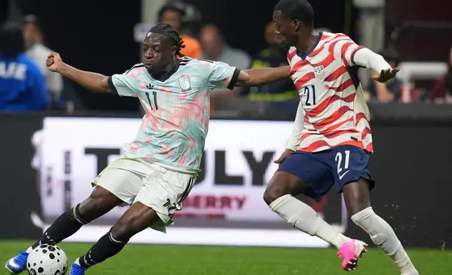 Belgium's Jeremy Doku moves against the United States' Timothy Weah (21) during an international friendly soccer match, Saturday, March 28, 2026, in Atlanta. (AP Photo/Mike Stewart)