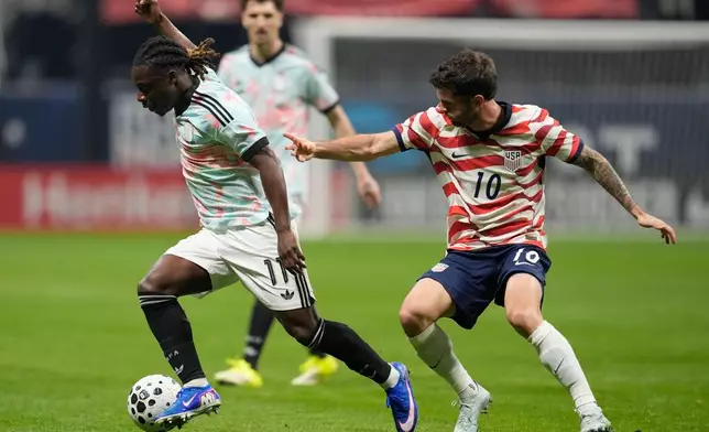 Belgium's Jeremy Doku (11) dribbles against the United States' Christian Pulisic (10) during the first half of an international friendly soccer match, Saturday, March 28, 2026, in Atlanta. (AP Photo/Mike Stewart)