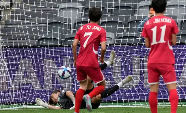 North Korea's Myong Yu Jong, centre, scores from the penalty spot as Uzbekistan's goalkeeper Zarina Saidova dives during the Women's Asia Cup soccer match between North Korea and Uzbekistan in Sydney, Tuesday, March 3, 2026. (AP Photo/Rick Rycroft)