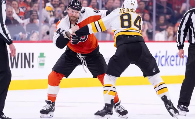 Philadelphia Flyers' Nicolas Deslauriers, left, gets into a fight with Boston Bruins' Tanner Jeannot, right, during the first period of an NHL hockey game Saturday, Feb. 28, 2026, in Philadelphia. (AP Photo/Chris Szagola)