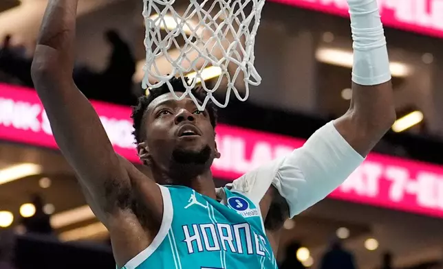 Charlotte Hornets forward Brandon Miller dunks against the Dallas Mavericks during the first half of an NBA basketball game, Tuesday, March 3, 2026, in Charlotte, N.C. (AP Photo/Chris Carlson)