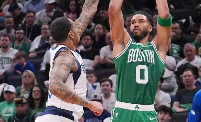 Boston Celtics forward Jayson Tatum (0) takes a shot over Dallas Mavericks forward P.J. Washington during the second half of an NBA basketball game, Friday, March 6, 2026, in Boston. (AP Photo/Charles Krupa)