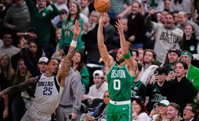 Boston Celtics forward Jayson Tatum (0) takes a 3-point shot against Dallas Mavericks forward P.J. Washington (25) during the first half of an NBA basketball game, Friday, March 6, 2026, in Boston. (AP Photo/Charles Krupa)