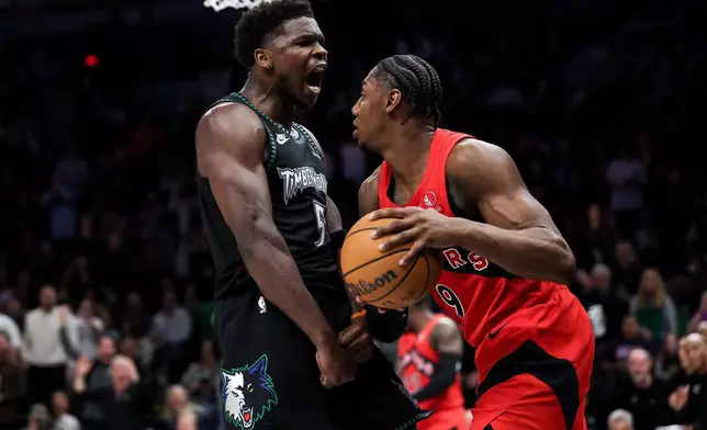 Minnesota Timberwolves guard Anthony Edwards (5) celebrates his dunk in front of Toronto Raptors forward RJ Barrett (9) during the second half of an NBA basketball game Thursday, March 5, 2026, in Minneapolis. (AP Photo/Matt Krohn)