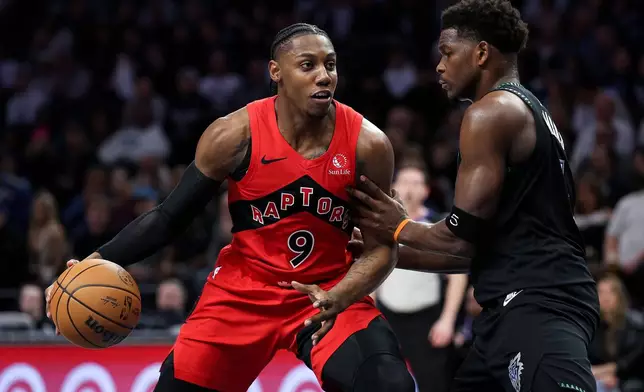 Toronto Raptors forward RJ Barrett, left, drives toward the basket as Minnesota Timberwolves guard Anthony Edwards defends during the first half of an NBA basketball game, Thursday, March 5, 2026, in Minneapolis. (AP Photo/Matt Krohn)