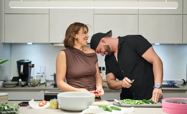 Gay Muslim influencer Ali Darwich, right, and Randa prepare food for an inclusive Iftar, the Ramadan fast-breaking meal, with friends who are Muslim, Christian, queer and straight, in Berlin, Germany, Wednesday, March 11, 2026. (AP Photo/Ebrahim Noroozi)