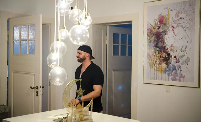 Gay Muslim influencer Ali Darwich, hosts an inclusive Iftar, the Ramadan fast-breaking meal, with friends who are Muslim, Christian, queer and straight, in Berlin, Germany, Wednesday, March 11, 2026. (AP Photo/Ebrahim Noroozi)