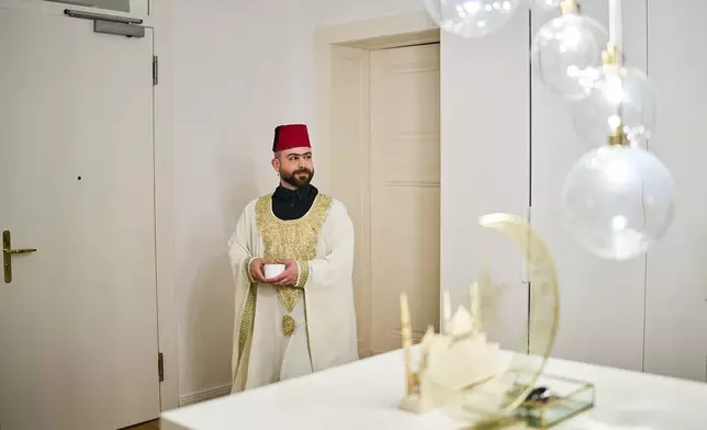 Haidar Darwish, a belly dancer and artist who came from Syria, attends an inclusive Iftar, the Ramadan fast-breaking meal, with friends who are Muslim, Christian, queer and straight, in Berlin, Germany, Wednesday, March 11, 2026. (AP Photo/Ebrahim Noroozi)