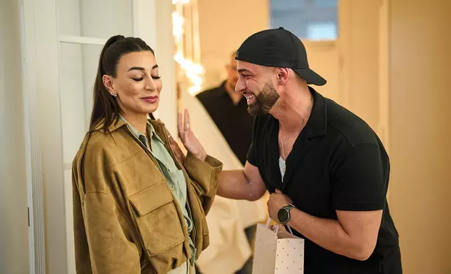 Gay Muslim influencer Ali Darwich, right, welcomes friends for an inclusive Iftar, the Ramadan fast-breaking meal, with friends who are Muslim, Christian, queer and straight, in Berlin, Germany, Wednesday, March 11, 2026. (AP Photo/Ebrahim Noroozi)