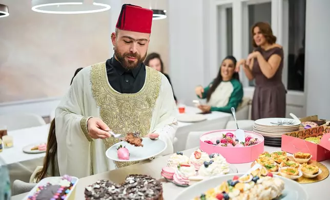 Haidar Darwish, a belly dancer and artist who came from Syria, attends an inclusive Iftar, the Ramadan fast-breaking meal, with friends who are Muslim, Christian, queer and straight, in Berlin, Germany, Wednesday, March 11, 2026. (AP Photo/Ebrahim Noroozi)