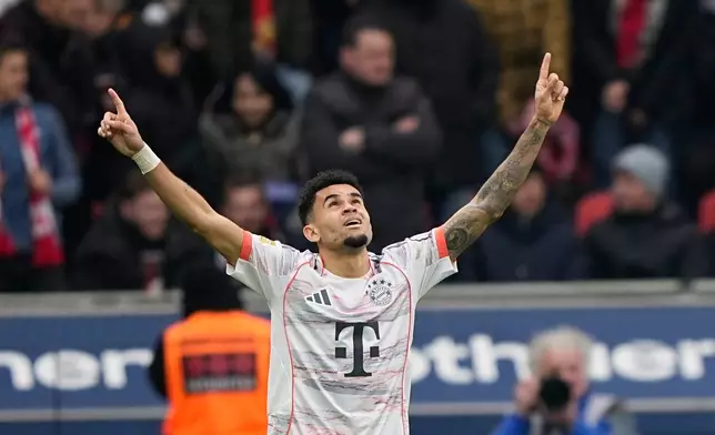 Bayern's Luis Diaz celebrates after scoring his side's opening goal during a German Bundesliga soccer match between Bayer Leverkusen and Bayern Munich in Leverkusen, Germany, Saturday, March 14, 2026. (AP Photo/Martin Meissner)