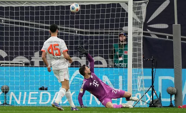 Bayern's goalkeeper Sven Ulreich fails to save the goal from Leverkusen's Aleix Garcia, unseen, during a German Bundesliga soccer match between Bayer Leverkusen and Bayern Munich in Leverkusen, Germany, Saturday, March 14, 2026. (AP Photo/Martin Meissner)