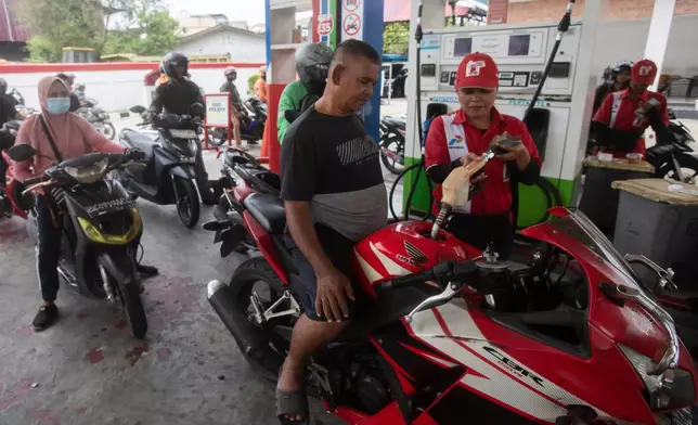 Motorists queue up to fill up their tank at a a petrol station in Medan, North Sumatra, Indonesia, on March 3, 2026. (AP Photo/Binsar Bakkara)