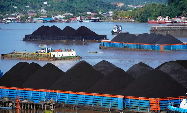 FILE- Barges fully loaded with coal are anchored on Mahakam river in Samarinda, East Kalimantan, Indonesia, on Dec. 19, 2022. (AP Photo/Dita Alangkara, File)