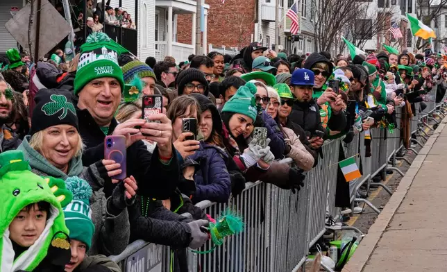 Spectators line up on Dorchester Avenue during the annual St. Patrick's Day parade through the South Boston neighborhood, Sunday, March 15, 2026, in Boston. (AP Photo/Charles Krupa)