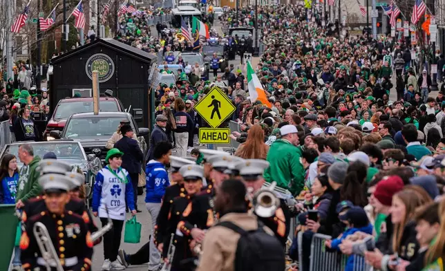 Marchers and floats pass hundreds of thousands of spectators during the annual St. Patrick's Day parade through the South Boston neighborhood, Sunday, March 15, 2026, in Boston. (AP Photo/Charles Krupa)