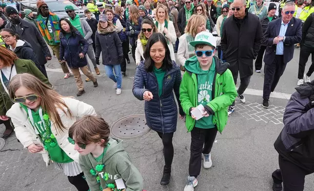 Boston Mayor Michelle Wu, center, marches through Andrew Square during the annual St. Patrick's Day parade through the South Boston neighborhood, Sunday, March 15, 2026, in Boston. (AP Photo/Charles Krupa)