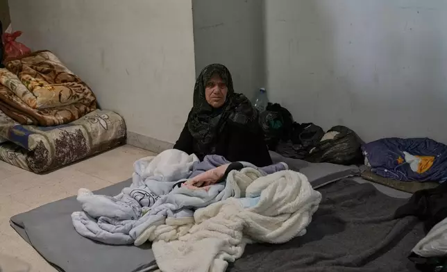 An elderly displaced woman who fled Israeli airstrikes with her family in southern Lebanon sits at the Bir Hassan Technical Institute, which has been turned into a shelter, in Beirut, Lebanon, Wednesday, March 11, 2026. (AP Photo/Bilal Hussein)