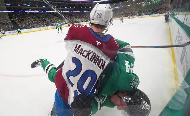 Colorado Avalanche center Nathan MacKinnon (29) and Dallas Stars center Roope Hintz (24) scuffle during the second period of an NHL hockey game Friday, March 6, 2026, in Dallas. (AP Photo/Julio Cortez)