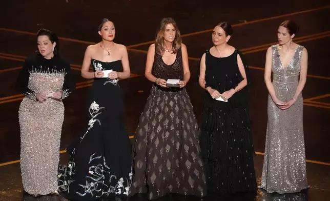 Melissa McCarthy, from left, Rose Byrne, Kristen Wiig, Maya Rudolph, and Ellie Kemper present the award for best original score during the Oscars on Sunday, March 15, 2026, at the Dolby Theatre in Los Angeles. (AP Photo/Chris Pizzello)