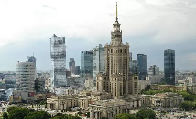 FILE - Newer skyscrapers flank the communist-era Palace of Culture and Science, foreground, in n, Poland, May 25, 2018. (AP Photo/Alik Keplicz, File)