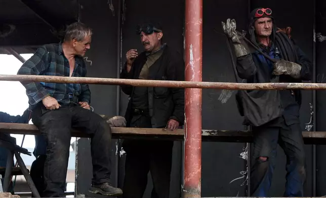 FILE - Workers stand together at a shipyard in Gdansk, Poland, Aug. 23, 2007. (AP Photo/Czarek Sokolowski, File)