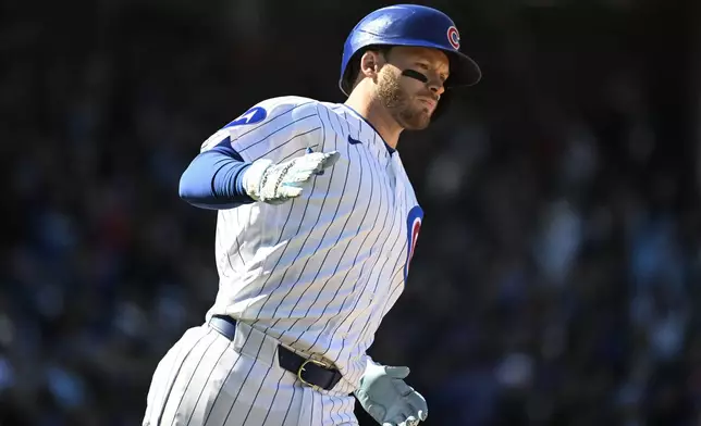 Chicago Cubs' Ian Happ rounds the bases after hitting a three-run home run delivers during the sixth inning of a baseball game against the Washington Nationals, Saturday, March 28, 2026, in Chicago. (AP Photo/Matt Marton)