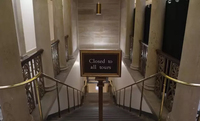 A sign at the top of the stairs near the plaque honoring police service on Jan. 6, 2021 at the Capitol, Saturday, March 7, 2026, in Washington. (AP Photo/Allison Robbert)