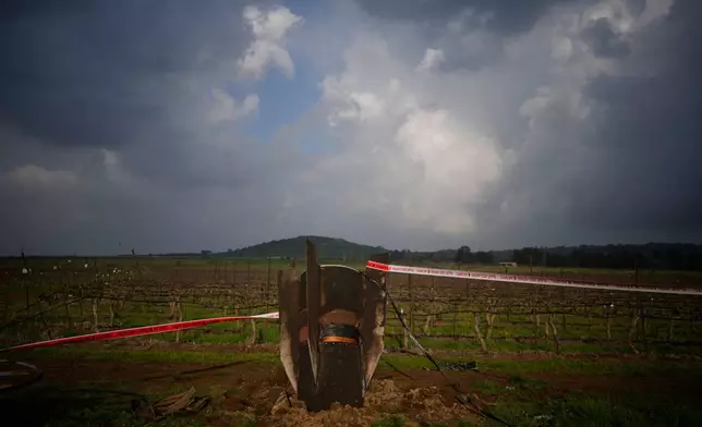 Fragment of a missile fired from Iran, and intercepted by Israeli defense system, sticks out in a open field in the Israeli-controlled Golan Heights, Thursday, March 19, 2026. (AP Photo/Ohad Zwigenberg)