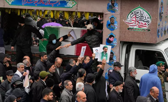 Iranians follow the funeral procession of Iran's intelligence minister Esmail Khatib and, according to Iranian officials, his wife and daughter, in Tehran, Iran, Friday, March 20, 2026. (AP Photo/Vahid Salemi)