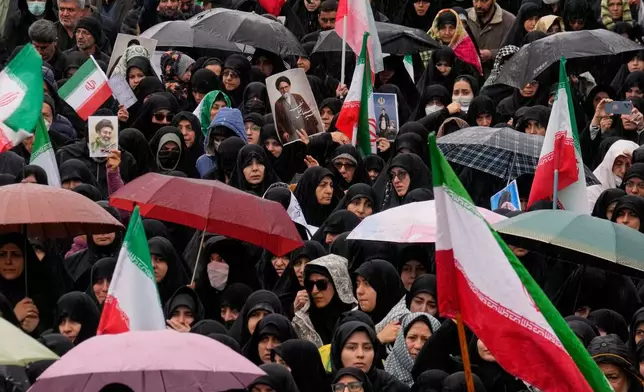 Iranians attend the funeral procession of Iran's intelligence minister Esmail Khatib and, according to Iranian officials, his wife and daughter, in Tehran, Iran, Friday, March 20, 2026. (AP Photo/Vahid Salemi)