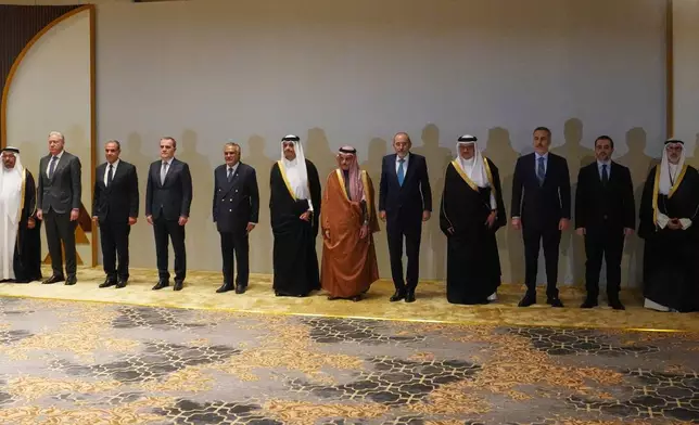 Saudi Arabia's Foreign Minister Prince Faisal bin Farhan Al-Saud, center, poses with foreign ministers before a consultative meeting of foreign ministers from a group of Arab and Islamic countries in the Saudi capital, Riyadh, Thursday, March 19, 2026. (AP Photo/Baraa Anwer)
