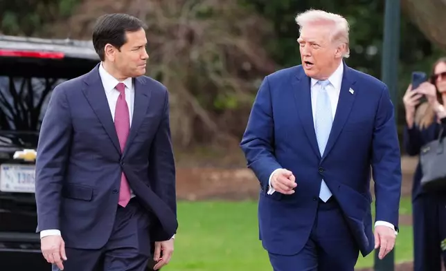 President Donald Trump walks with Secretary of State Marco Rubio before departing on Marine One from the South Lawn of the White House, Friday, March 20, 2026, in Washington. (AP Photo/Alex Brandon)