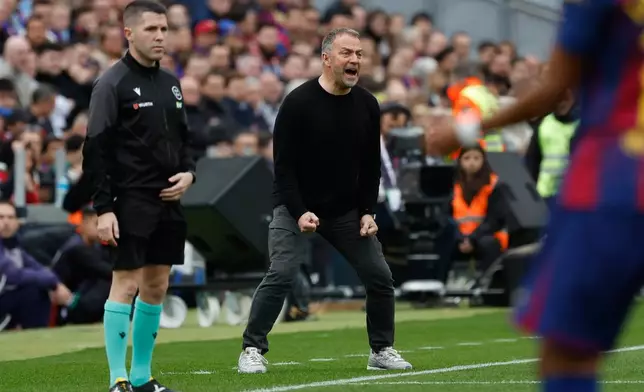 Barcelona's head coach Hansi Flick, center, reacts during the Spanish La Liga soccer match between Barcelona and Villareal in Barcelona, Spain, Saturday, Feb. 28, 2026. (AP Photo/Joan Monfort)