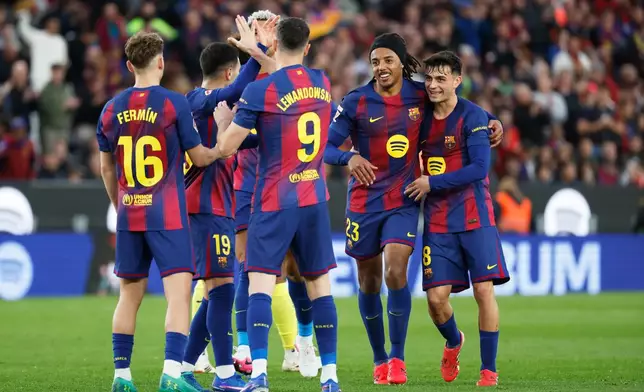 Barcelona's Robert Lewandowski (9) is congratulated after scoring his side's 4th goal during the Spanish La Liga soccer match between Barcelona and Villareal in Barcelona, Spain, Saturday, Feb. 28, 2026. (AP Photo/Joan Monfort)
