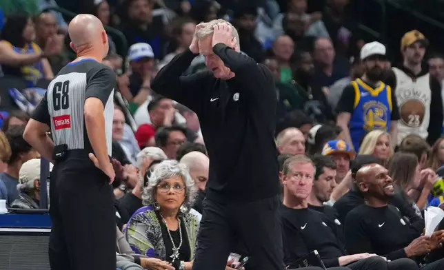 Golden State Warriors head coach Steve Kerr, right, reacts in front of referee Jacyn Goble (68) during the first half of an NBA basketball game against the Dallas Mavericks Monday, March 23, 2026, in Dallas. (AP Photo/Julio Cortez)