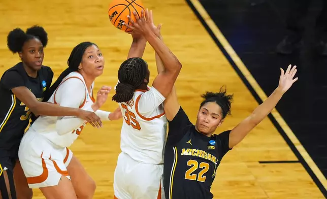 Texas forward Madison Booker (35) shoots on Michigan forward Kendall Dudley (22) during the first half in the Elite Eight of the NCAA college basketball tournament, Monday, March 30, 2026, in Fort Worth, Texas. (AP Photo/LM Otero)