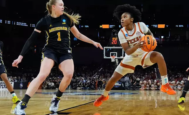 Texas guard Rori Harmon (3) steps back to shoot on Michigan guard Olivia Olson (1) during the first half in the Elite Eight of the NCAA college basketball tournament, Monday, March 30, 2026, in Fort Worth, Texas. (AP Photo/Tony Gutierrez)