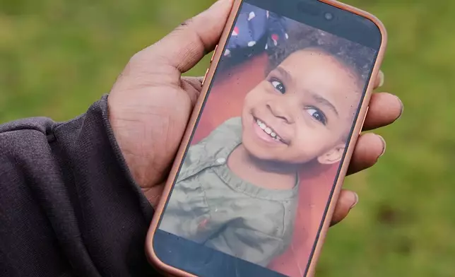 DeShaun Chatman, the father of Mila Chatman, one of the two girls whose bodies were found earlier this week, shows a photo of his daughter Mila Chatman, taken in 2020, at the site the bodies were found, in Cleveland, Thursday, March 5, 2026. (AP Photo/Sue Ogrocki)